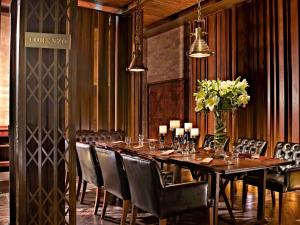 a dining room table with two chairs and a table cloth at Hotel Muse Bangkok Langsuan - MGallery - SHA EXTRA PLUS in Bangkok