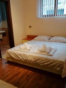 a bedroom with a bed with towels on it at Villa Mareli in Tsarevo