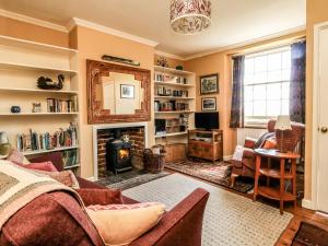 a living room with a couch and a fireplace at Bedford Terrace in Bridport