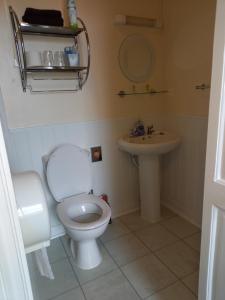 a bathroom with a toilet and a sink at Crofton Guest House in Weymouth