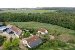 an aerial view of an old house in a field at Chambres d hôtes de la Mauguinière in Neuillé-le-Lierre