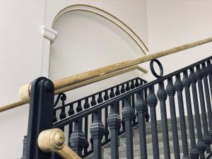 a stair railing with a wrought iron rail at The Gold Bank in Prague