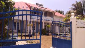 a blue gate in front of a house at Sur L'Anse in Terre-de-Haut