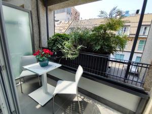 a balcony with a table and chairs and plants at Enjoy Duomo - Flavio Baracchini 9 in Milan