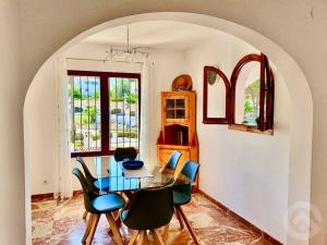 a dining room with a glass table and chairs at Luciana in Moraira