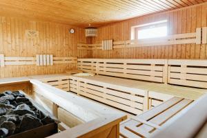 a sauna with wooden walls and tables and a window at HEIMATEL - Rosenalm Scheidegg in Scheidegg
