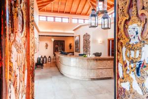 a lobby with a large wall with paintings on it at Hotel Botanico y Oriental Spa Garden in Puerto de la Cruz +52 photos