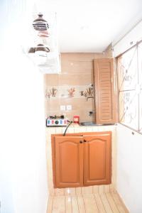 a kitchen with an orange cabinet in a room at Studio Amine avec une terasse privée in Rabat
