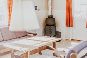 a living room with a couch and a wood stove at Hovden Høyfjellsenter in Hovden