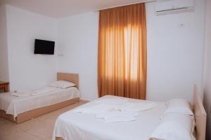 Ένα ή περισσότερα κρεβάτια σε δωμάτιο στο Hotel Perdja