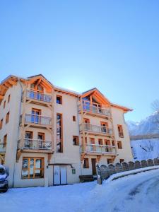 a building in the snow with a car parked in front at Mont Blanc in Peisey-Nancroix