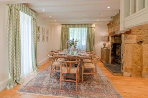 a dining room with a table and chairs at Colebrook Cottage in Blockley