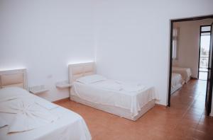 Ένα ή περισσότερα κρεβάτια σε δωμάτιο στο Hotel Perdja