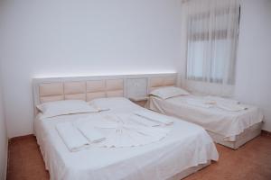 Ένα ή περισσότερα κρεβάτια σε δωμάτιο στο Hotel Perdja