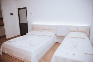 Ένα ή περισσότερα κρεβάτια σε δωμάτιο στο Hotel Perdja