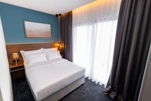 Postel nebo postele na pokoji v ubytování Boutique ROOMs 76