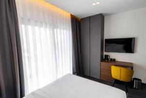Postel nebo postele na pokoji v ubytování Boutique ROOMs 76