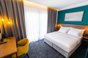 Postel nebo postele na pokoji v ubytování Boutique ROOMs 76