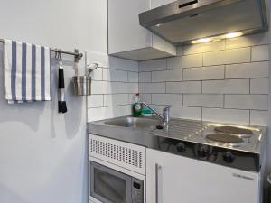 a kitchen with a sink and a microwave at THE STUDIO MAIDENHEAD RIVERSIDE in Maidenhead