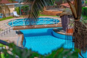 a swimming pool with a fountain in a yard at KenGen Furnished and Serviced Apartments in Nairobi
