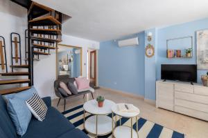a living room with a blue couch and a staircase at Villa Gradina in Vela Luka