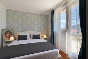 a bedroom with a white bed and a window at Villa Gradina in Vela Luka +53 photos