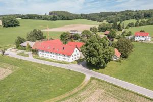 an aerial view of a large white house with a red roof at Ferienwohnung Häfele 1 in Bad Wurzach