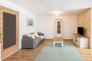 a living room with a couch and a table at Ferienwohnung Häfele 1 in Bad Wurzach