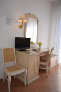 a desk with a computer and a chair and a mirror at Hotel I Due Gabbiani CITR 9006 in Marina di Andora