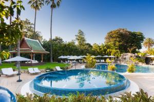 a pool with a lawn chair in front of it at Hotel Botanico y Oriental Spa Garden in Puerto de la Cruz