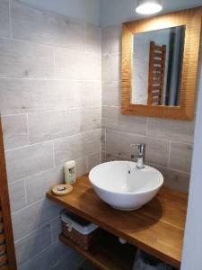 a bathroom with a white sink and a mirror at Appartement de vacances à la campagne in Saint-Jean-Pla-de-Corts +4 photos