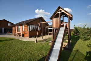 a playground with a slide in front of a house at Мигдаль Маєток in Svityazʼ