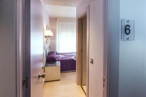 a hotel room with a bed and a door at Pensión Plaza in Santander