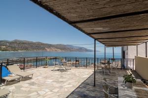a patio with a view of the water at Harbour Studios And Apartments in Palaiochóra