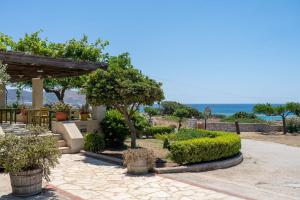 a garden with a view of the ocean at Adam in Falasarna