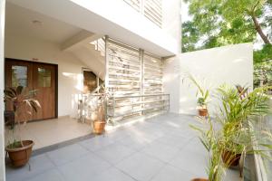 a courtyard with potted plants in a house at Nova Sahaj Residency in Khirasra