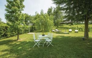 a table and chairs in the grass in a yard at Capriva Del Friuli - CASA RONCUS in Capriva del Friuli