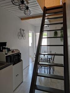 a staircase leading to a kitchen with a table at L'ENTRE-TEMPS in Chambretaud