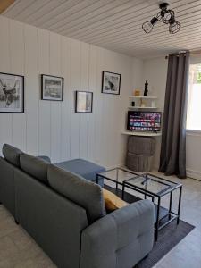 a living room with a couch and a table at L'ENTRE-TEMPS in Chambretaud