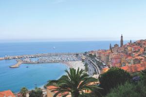 a view of a city with a harbor and the ocean at Hôtel Miléade L'Orangeraie - Menton in Menton