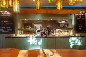 a restaurant with a counter with food on display at Europa Hotel Kühlungsborn in Kühlungsborn