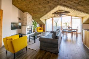 a living room with a couch and chairs and a table at XOX Apart Hotel in Akyaka