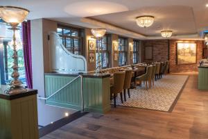 a restaurant with a long row of tables and chairs at Europa Hotel Kühlungsborn in Kühlungsborn