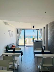 a living room with tables and a view of the ocean at CARFAGNINI ROOMS in Termoli