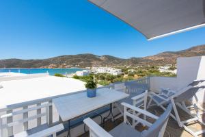 a view from the balcony of a villa with a table and chairs at NEFELI'S GUESTHOUSE IN PLATYS GIALOS SIFNOS in Platis Gialos