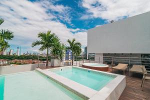 a swimming pool on the roof of a building at GOLDFLAT - Manaíra by PenareiaTurBr in João Pessoa