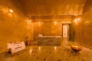 a large room with a tub and a bowl on the floor at Hotel Sahrai in Fès