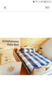 a bedroom with a bed and a baby crib at 4 Erw. 1 Ki. Ski Entspannung Terasse Ausblick in Schmallenberg