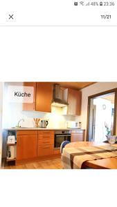 a kitchen with a bed and a kitchen with a table at 4 Erw. 1 Ki. Ski Entspannung Terasse Ausblick in Schmallenberg