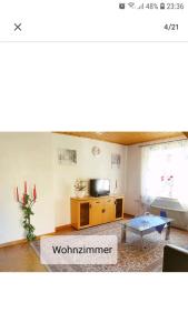 a living room with a television and a table at 4 Erw. 1 Ki. Ski Entspannung Terasse Ausblick in Schmallenberg